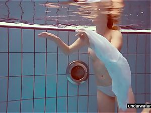 super-cute red-haired plays bare underwater